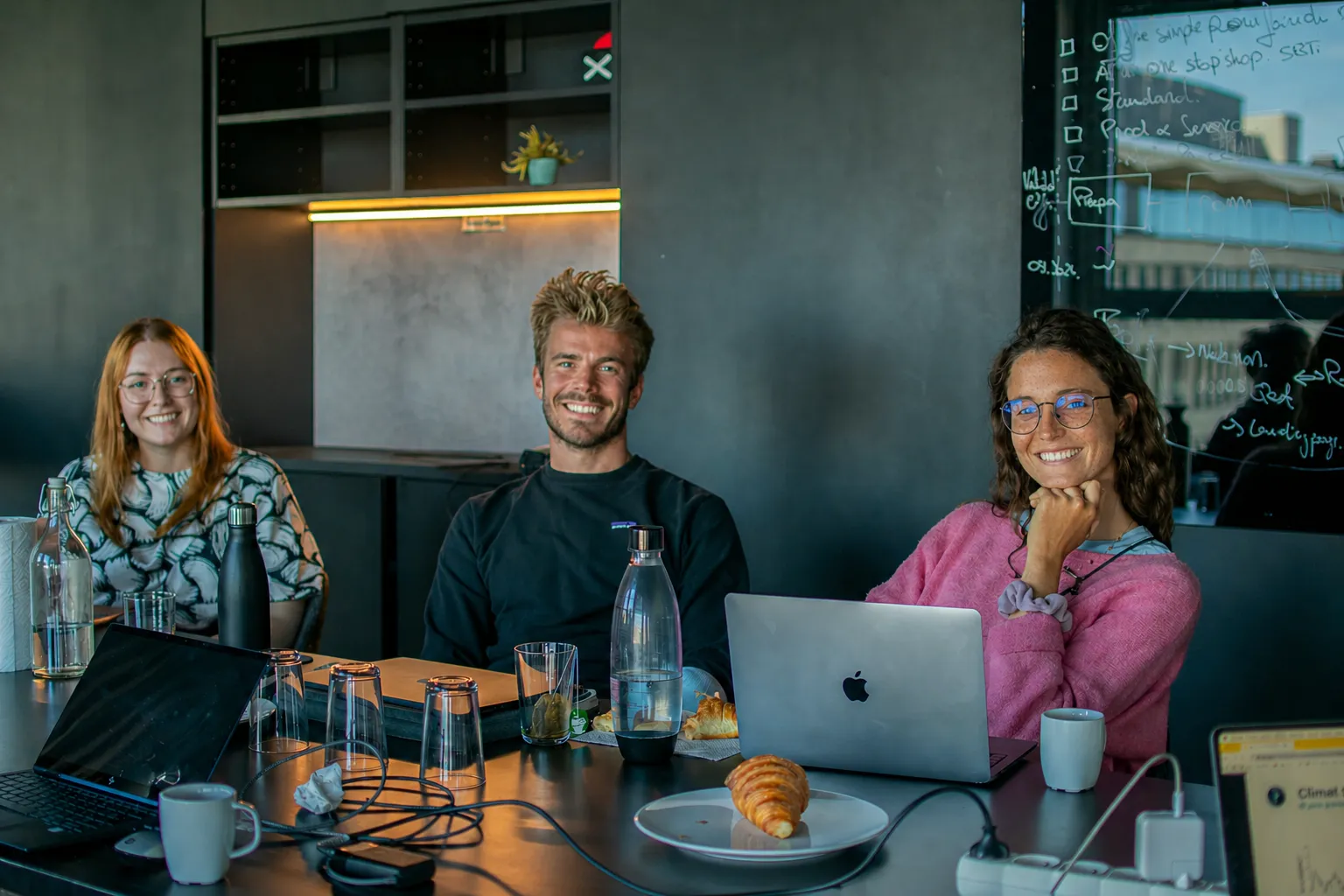 A solution provider team meeting and smiling around a table