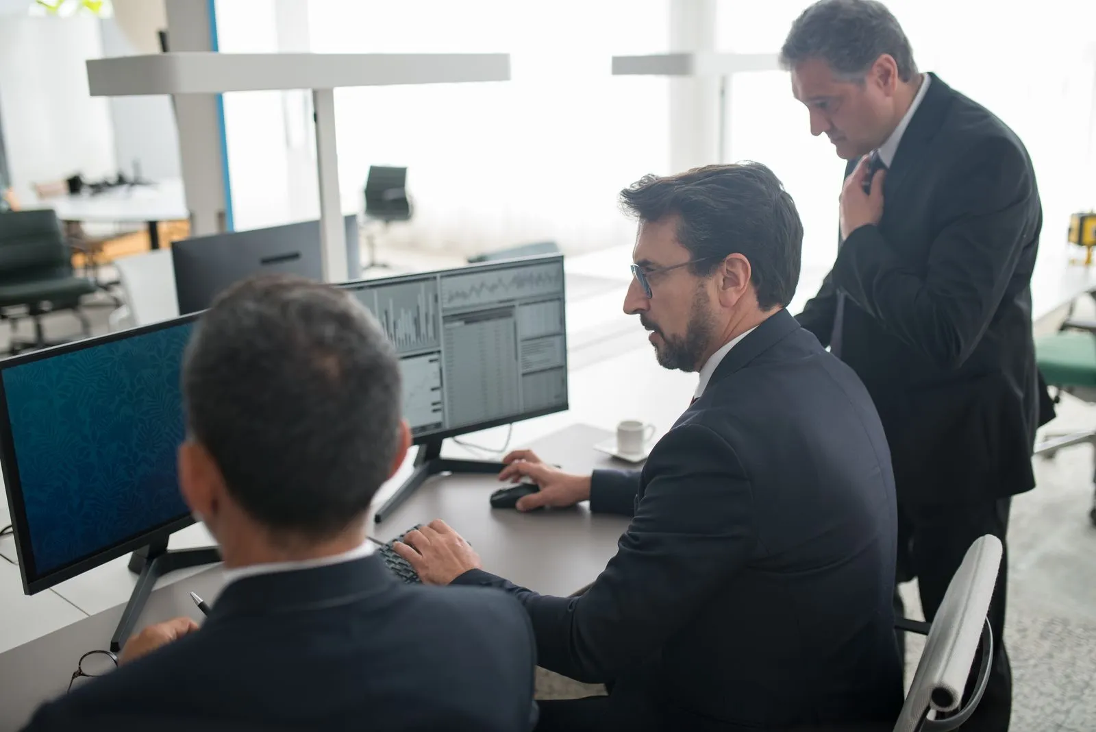 Financial analysts reviewing market data on screens