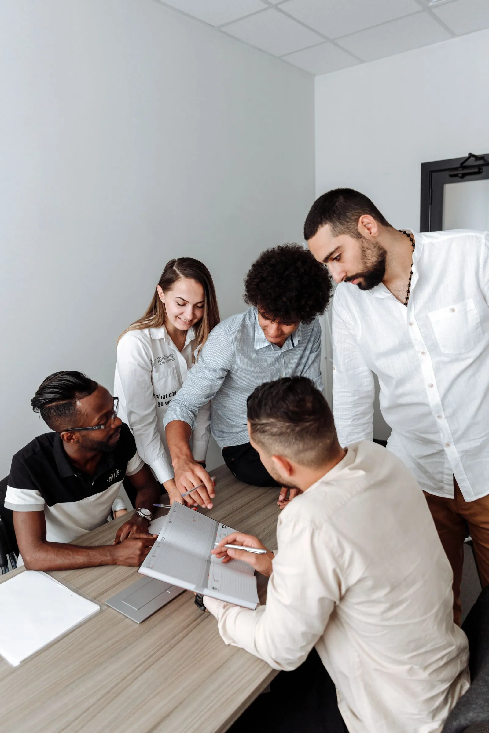 A team gathered around a table, working together on their decarbonation plan