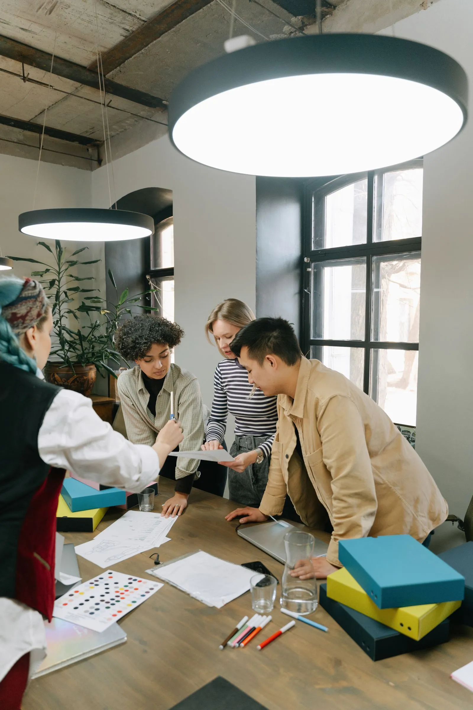 a team collaborating around a table with plants